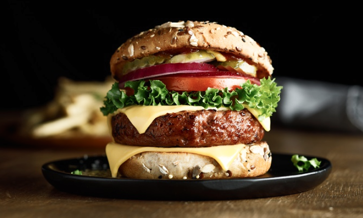 plant-based burger with cheese, lettuce, tomato
